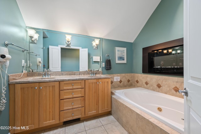 full bath with vaulted ceiling, a tub with jets, double vanity, and tile patterned flooring