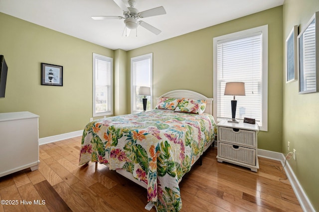 bedroom with wood-type flooring and a ceiling fan
