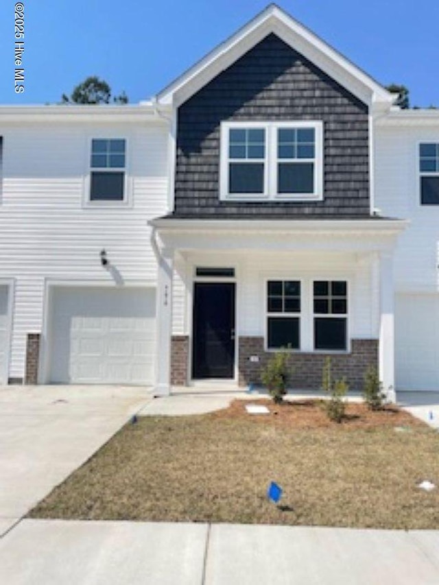 796 Palm Frond Way Unit 47, Calabash, NC 28467 - view of front of property with an attached garage, driveway, a porch, and brick siding
