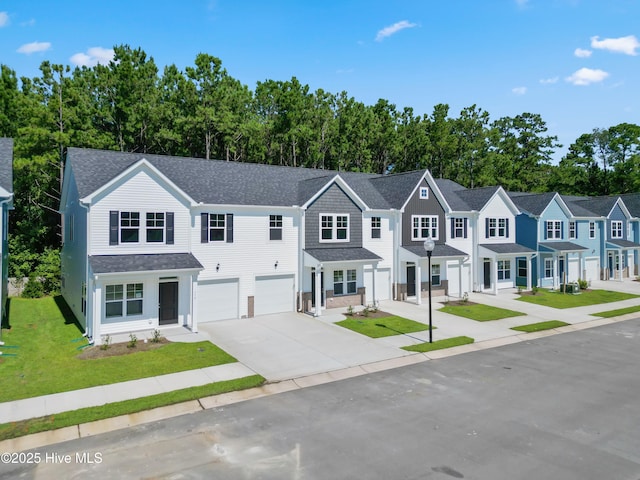 796 Palm Frond Way Unit 47, Calabash, NC 28467 - townhome / multi-family property with concrete driveway, a garage, a front yard, a residential view, and roof with shingles
