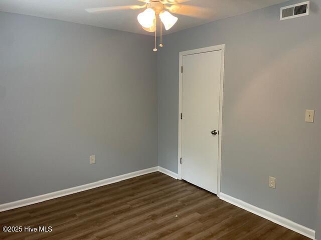 3309 Bridges St Unit 12, Morehead City, NC 28557 - spare room with ceiling fan, dark wood finished floors, and baseboards