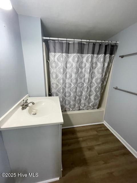 3309 Bridges St Unit 12, Morehead City, NC 28557 - full bath with shower / tub combo, vanity, wood finished floors, and baseboards