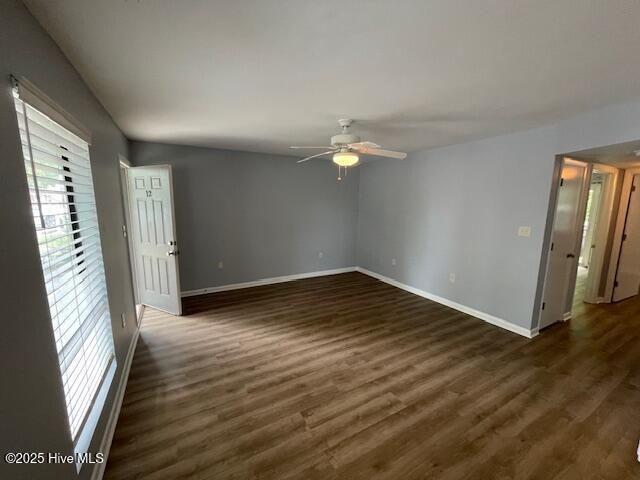 3309 Bridges St Unit 12, Morehead City, NC 28557 - spare room featuring ceiling fan, baseboards, and dark wood-style flooring