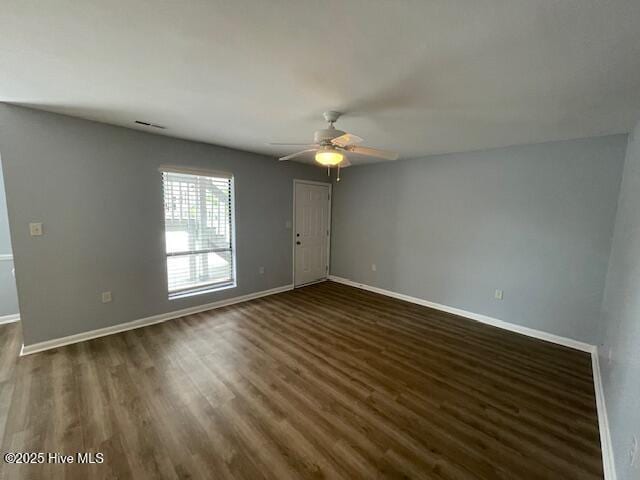 3309 Bridges St Unit 12, Morehead City, NC 28557 - spare room with ceiling fan, dark wood-style flooring, and baseboards