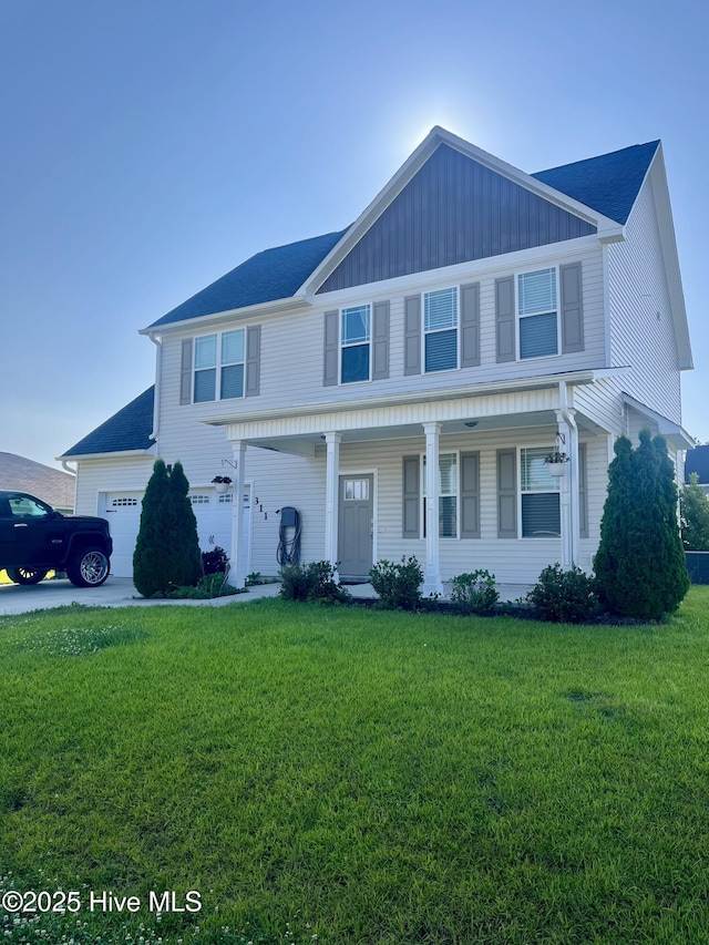 311 Adobe Ln, Jacksonville, NC 28546 - view of front facade with a front lawn, a porch, a garage, and a shingled roof