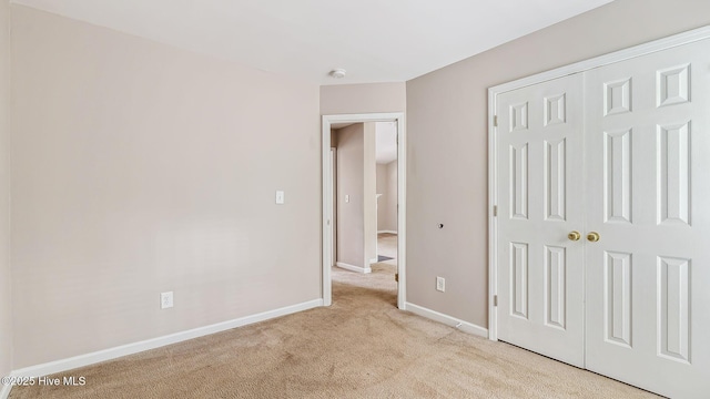 149 Edinburgh Dr, Carthage, NC 28327 - unfurnished bedroom featuring light colored carpet, a closet, and baseboards
