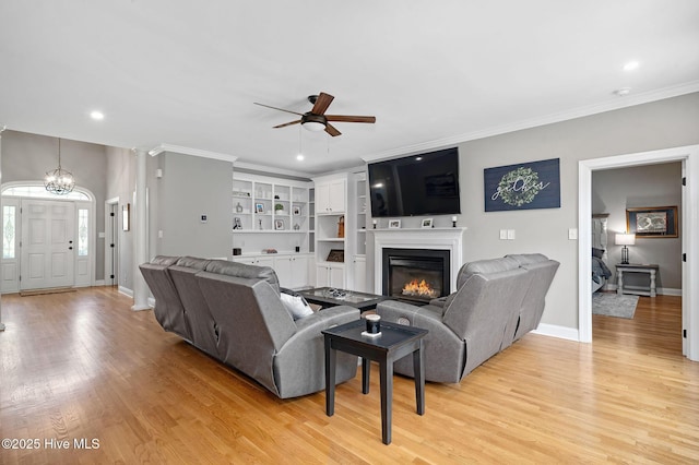 224 Red Fox Run Dr, Wallace, NC 28466 - living area with a ceiling fan, light wood finished floors, a glass covered fireplace, ornamental molding, and recessed lighting