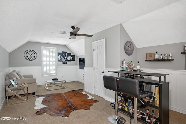224 Red Fox Run Dr, Wallace, NC 28466 - living room with a wainscoted wall, vaulted ceiling, ceiling fan, carpet floors, and a textured ceiling