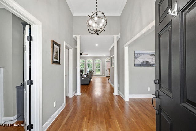 224 Red Fox Run Dr, Wallace, NC 28466 - foyer entrance with light wood-type flooring, decorative columns, ornamental molding, baseboards, and a chandelier