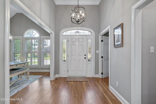 224 Red Fox Run Dr, Wallace, NC 28466 - entrance foyer with a chandelier, wood finished floors, baseboards, a high ceiling, and ornamental molding