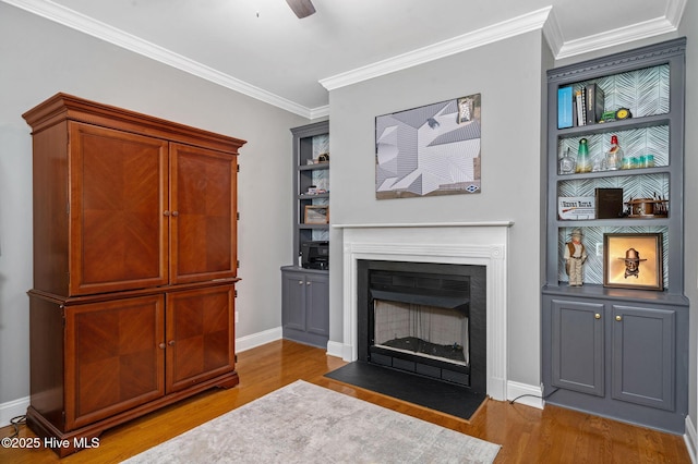 224 Red Fox Run Dr, Wallace, NC 28466 - living area featuring wood finished floors, a fireplace with flush hearth, crown molding, baseboards, and a ceiling fan