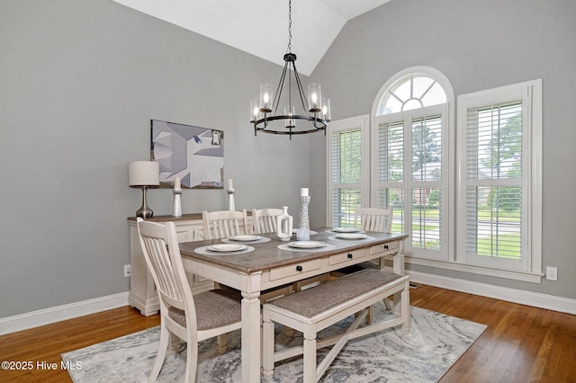 224 Red Fox Run Dr, Wallace, NC 28466 - dining room with a chandelier, vaulted ceiling, wood finished floors, and baseboards