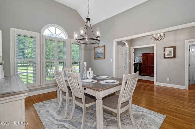 224 Red Fox Run Dr, Wallace, NC 28466 - dining area with a chandelier, vaulted ceiling, wood finished floors, and baseboards