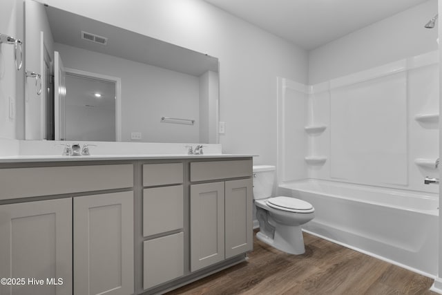 786 Palm Frond Way Unit 51, Calabash, NC 28467 - bathroom featuring toilet, double vanity, wood finished floors, and washtub / shower combination