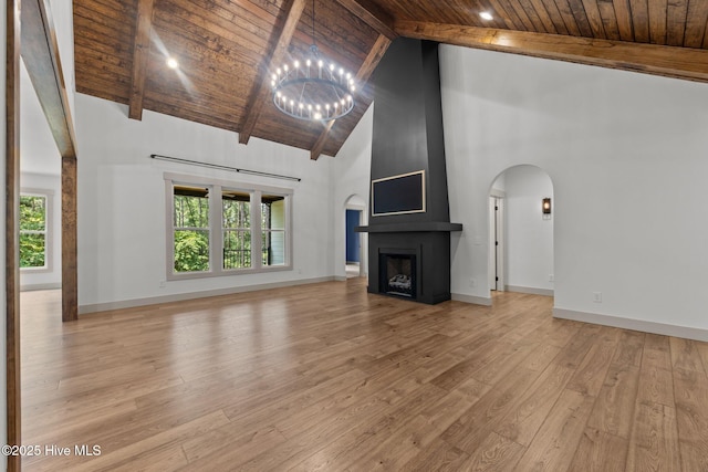 499 Longleaf Dr, West End, NC 27376 - unfurnished living room with wooden ceiling with exposed beams, high vaulted ceiling, a chandelier, arched walkways, and light wood-style flooring