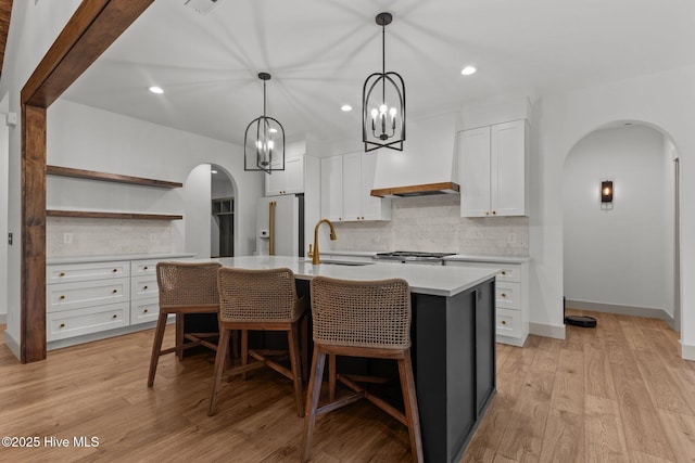 499 Longleaf Dr, West End, NC 27376 - kitchen with arched walkways, high quality fridge, a sink, decorative backsplash, and recessed lighting