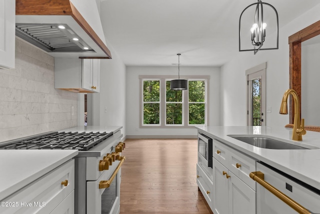 499 Longleaf Dr, West End, NC 27376 - kitchen with double oven range, a sink, dishwashing machine, wall chimney range hood, and stainless steel microwave