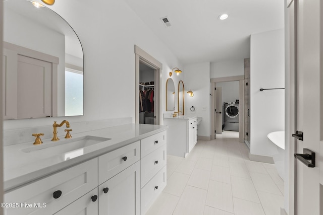 499 Longleaf Dr, West End, NC 27376 - bathroom with washer / clothes dryer, vanity, a spacious closet, tile patterned floors, and recessed lighting