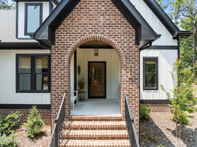 499 Longleaf Dr, West End, NC 27376 - property entrance featuring brick siding, board and batten siding, and roof with shingles