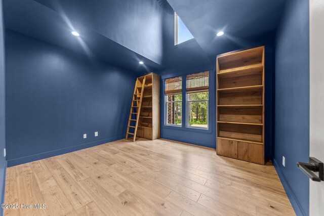 499 Longleaf Dr, West End, NC 27376 - spare room featuring wood finished floors, high vaulted ceiling, recessed lighting, and baseboards