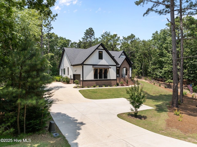 499 Longleaf Dr, West End, NC 27376 - modern farmhouse style home featuring concrete driveway, a front lawn, board and batten siding, and a shingled roof