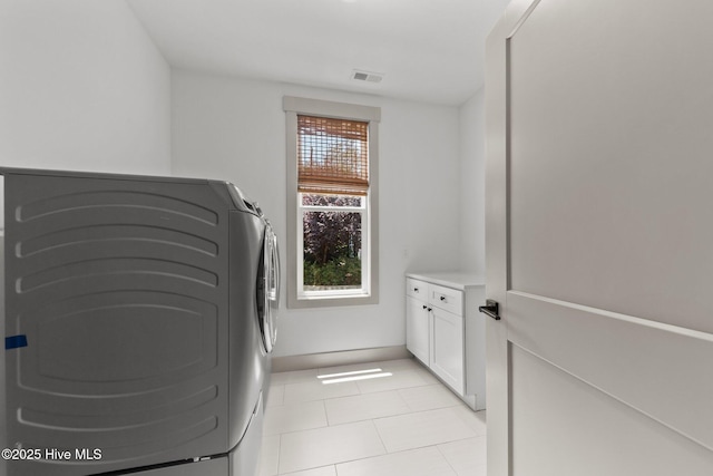 499 Longleaf Dr, West End, NC 27376 - laundry area featuring light tile patterned floors, washer and clothes dryer, and cabinet space