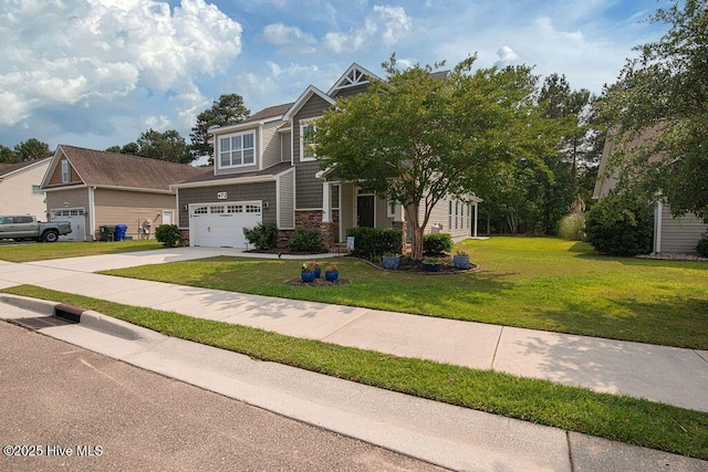 472 Landsdowne Cir, Hampstead, NC 28443 - craftsman-style home with concrete driveway, stone siding, a garage, and a front lawn
