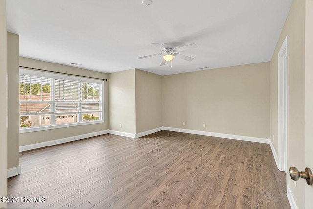 472 Landsdowne Cir, Hampstead, NC 28443 - spare room with wood finished floors, ceiling fan, and baseboards