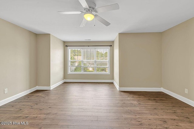 472 Landsdowne Cir, Hampstead, NC 28443 - empty room with wood finished floors, baseboards, and a ceiling fan