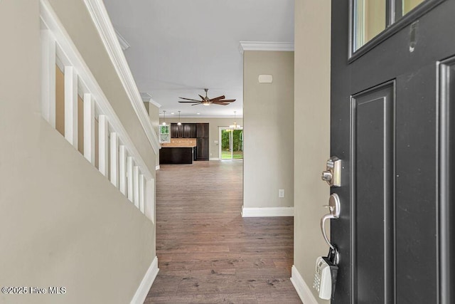 472 Landsdowne Cir, Hampstead, NC 28443 - entryway with crown molding, baseboards, wood finished floors, and ceiling fan