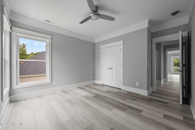 505 N Shore Dr, Sneads Ferry, NC 28460 - unfurnished bedroom with light wood-type flooring, crown molding, baseboards, and a closet