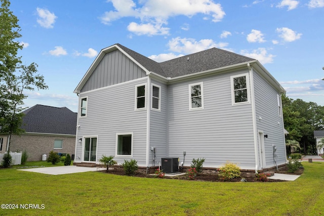 505 N Shore Dr, Sneads Ferry, NC 28460 - rear view of property featuring a patio area, board and batten siding, a lawn, and cooling unit