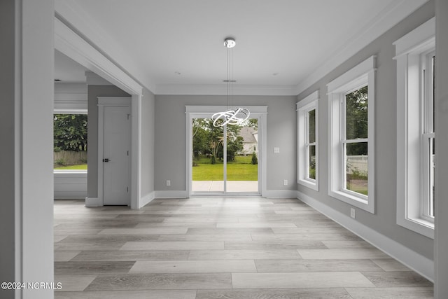 505 N Shore Dr, Sneads Ferry, NC 28460 - unfurnished dining area featuring healthy amount of natural light, a chandelier, baseboards, and crown molding