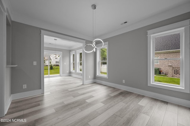 505 N Shore Dr, Sneads Ferry, NC 28460 - unfurnished dining area with ornamental molding, light wood-style floors, baseboards, and a chandelier