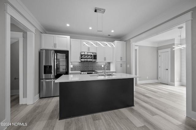 505 N Shore Dr, Sneads Ferry, NC 28460 - kitchen with appliances with stainless steel finishes, white cabinetry, light countertops, tasteful backsplash, and a center island with sink