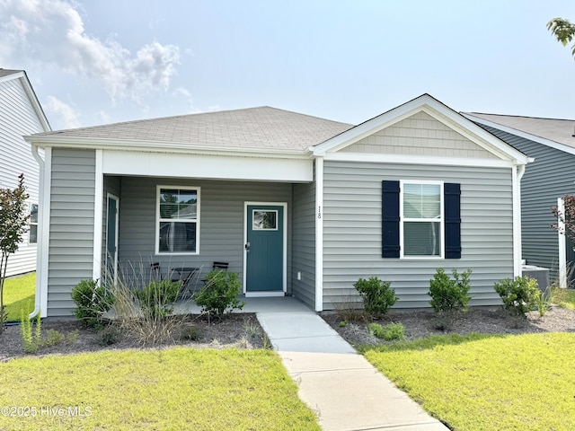 18 Landward Way, Wilmington, NC 28411 - view of front of home featuring a front yard, a porch, central AC, and roof with shingles