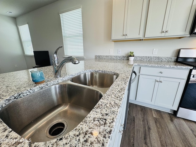 18 Landward Way, Wilmington, NC 28411 - kitchen with stainless steel range, a sink, dark wood-style flooring, light stone countertops, and white cabinetry