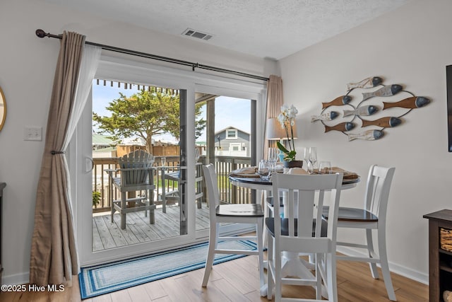 9100 Reed Dr Unit 3107, Emerald Isle, NC 28594 - dining room featuring wood finished floors and a textured ceiling