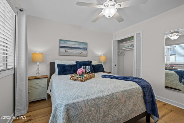 9100 Reed Dr Unit 3107, Emerald Isle, NC 28594 - bedroom featuring light wood-style flooring, a ceiling fan, baseboards, and a closet
