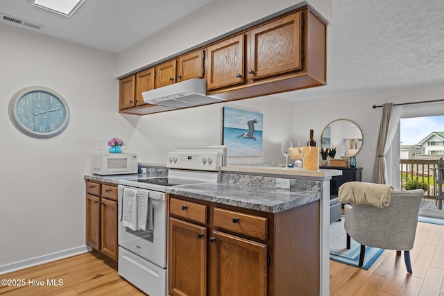 9100 Reed Dr Unit 3107, Emerald Isle, NC 28594 - kitchen featuring white appliances, light wood finished floors, and brown cabinetry