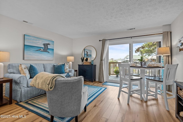 9100 Reed Dr Unit 3107, Emerald Isle, NC 28594 - living area featuring wood finished floors and a textured ceiling