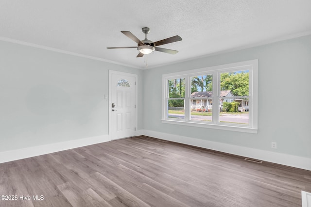 76 Lee Dr, Leland, NC 28451 - spare room featuring wood finished floors, ceiling fan, baseboards, and crown molding