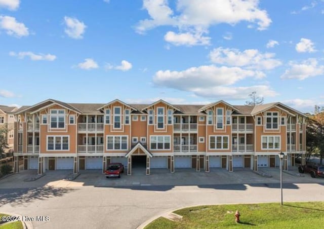 100 Mercedes Ct Unit F, Grandy, NC 27939 - view of building exterior with driveway and a garage