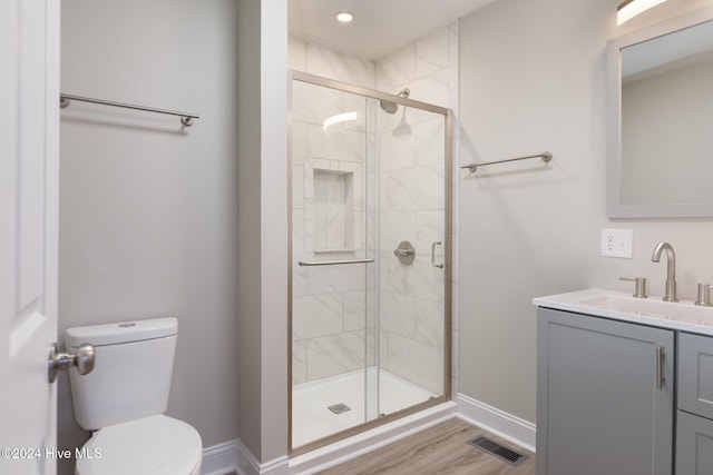 212 Tram Rd, West End, NC 27376 - bathroom featuring toilet, vanity, a stall shower, baseboards, and wood finished floors