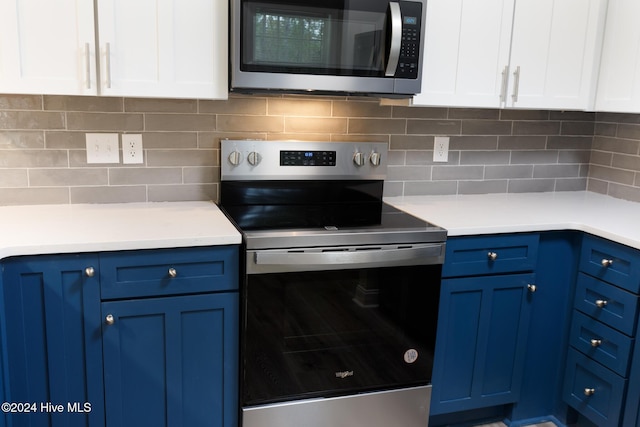 212 Tram Rd, West End, NC 27376 - kitchen featuring appliances with stainless steel finishes, blue cabinetry, light countertops, white cabinets, and decorative backsplash