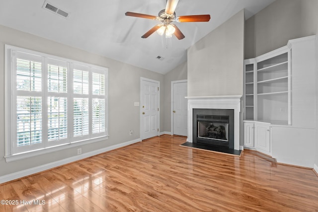 3782 Loblolly Dr, Rocky Mount, NC 27804 - unfurnished living room with wood finished floors, a fireplace, a ceiling fan, baseboards, and high vaulted ceiling