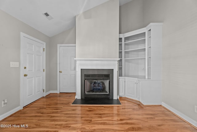 3782 Loblolly Dr, Rocky Mount, NC 27804 - unfurnished living room with lofted ceiling, wood finished floors, and baseboards