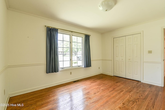 103 Loblolly Dr, Plymouth, NC 27962 - unfurnished bedroom featuring ornamental molding, wood finished floors, a closet, and baseboards