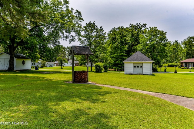 103 Loblolly Dr, Plymouth, NC 27962 - view of green lawn featuring a garage, an outbuilding, and view of scattered trees
