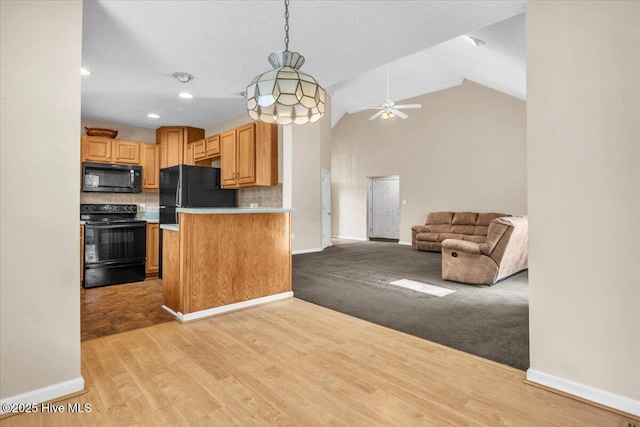734 Sloop Pointe Ln, Kure Beach, NC 28449 - kitchen with black appliances, ceiling fan, baseboards, tasteful backsplash, and pendant lighting